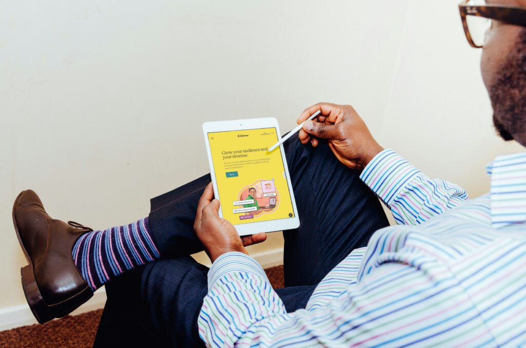 Branding specialist presenting a rebranding strategy to a small business team with updated visuals on a screen.