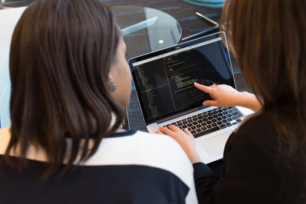 Professional IT consultant presenting a digital transformation strategy to business leaders with data dashboards and system architecture visuals.