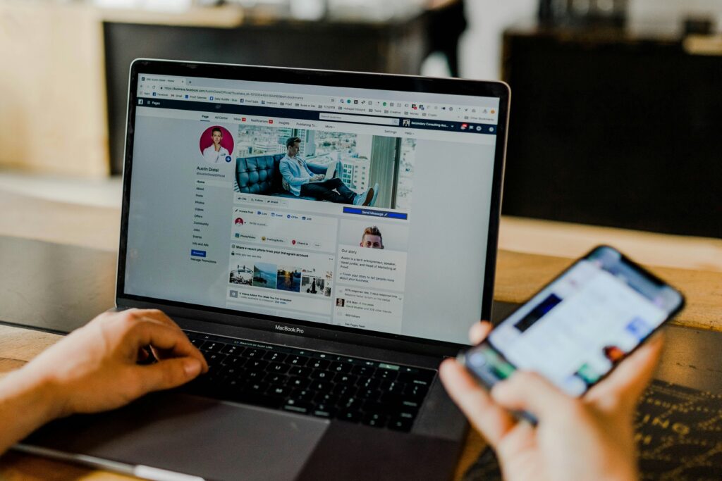 Social media manager analyzing traffic metrics on laptop with graphs and social media icons illustrating digital marketing strategy.